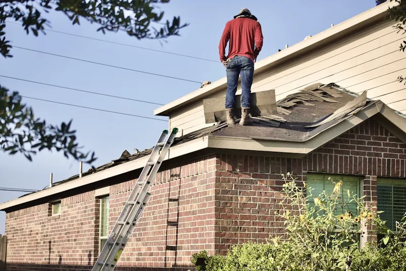 Professional roofer working on a residential roof in Southfield